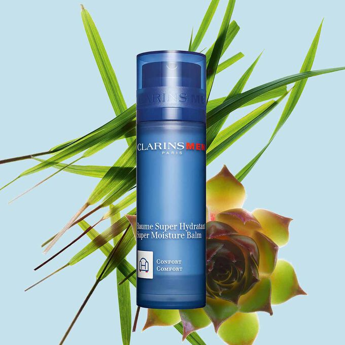 Pakkebilde av en pumpeflaske med ClarinsMen Super Moisture Balm i nærheten av gymnena og marigress mot en blå bakgrunn.