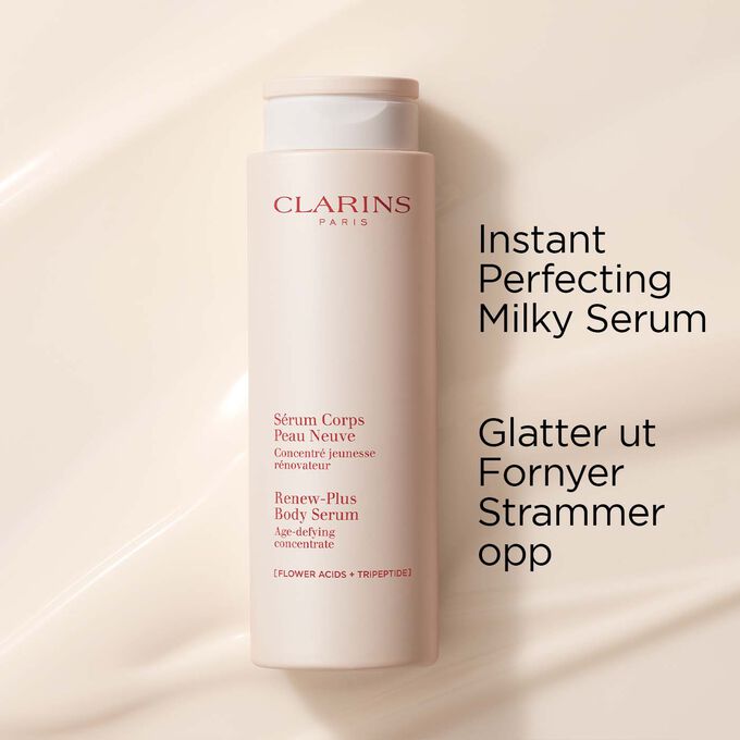 Clarins Instant Perfecting Milky Serum for kroppen på en strukturert kremet bakgrunn for å fremheve de utglattende og oppstrammende egenskapene
