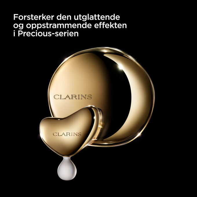 Bilde av Clarins massasjeverktøy mot en mørk bakgrunn med tekst som fremhever nytten for Precious-serien.