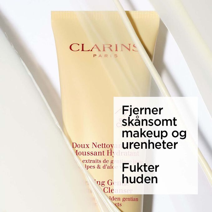 Packshot av den gule tuben med Clarins fuktighetsgivende skummende ansiktsrens under skum med tekst om dens beroligende effekt.