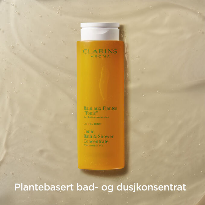 Pakkebilde av Clarins Tonic Bath and Shower Concentrate med tekst som fremhever at det er en velduftende plantebasert dusjgel.