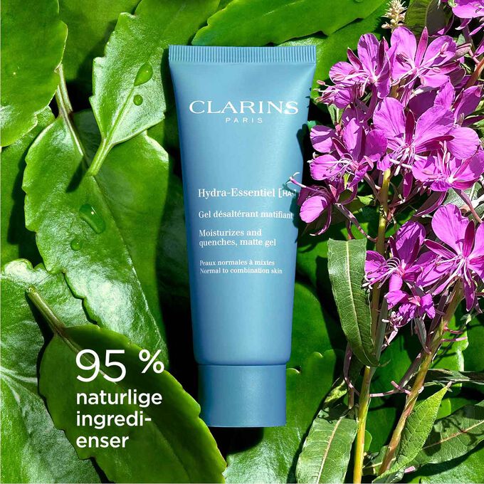 Pakkebilde av Clarins Hydra-Essentiel Matte Gel blant geitrams som fremhever at den inneholder 92 % naturlige ingredienser.