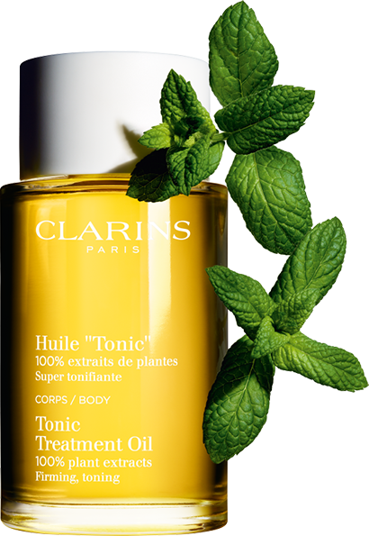 Tonic body treatment oil bottle and mint leaves